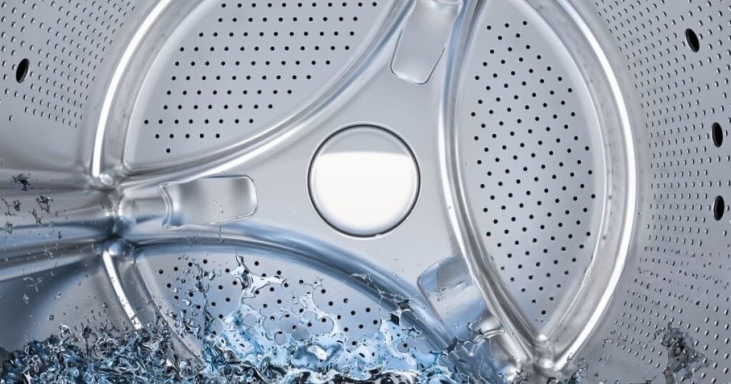 Close-up of a washing machine drum with water inside, illustrating drainage issues. Learn how to fix a washing machine that won’t drain by checking for clogged drain hoses, faulty pumps, or a blocked filter to restore proper functionality
